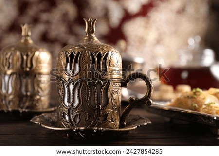 Traditional Turkish tea served in vintage tea set on wooden table