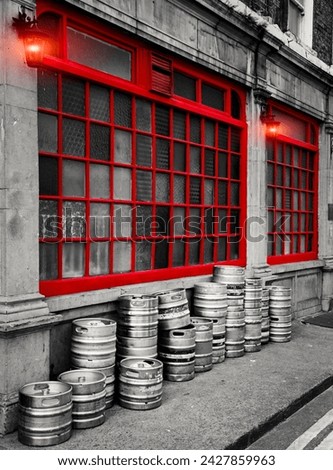 Dublin Street, Row of stacked beer kegs outside of a building.  The image shows a part of a traditional pub in Dublin showcasing its classic architectural design. 
