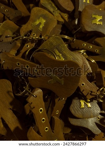 Pile of Wooden Guitar Keychains with Letter K
