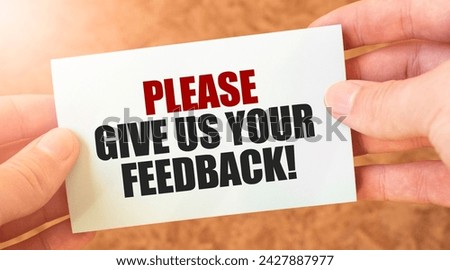 PLEASE GIVE US YOUR FEEDBACK word inscription on white card paper sheet in hands of a businessman. Royalty-Free Stock Photo #2427887977