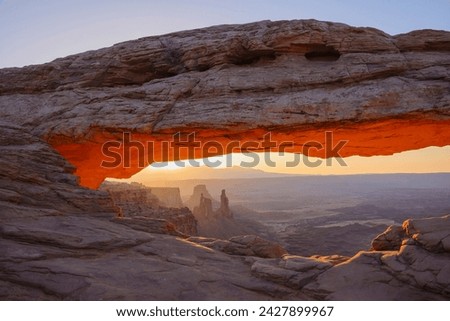 Mesa arch at dawn looking towards washerwoman arch, islands in the sky section of canyonlands national park, utah, united states of america, north america Royalty-Free Stock Photo #2427899967