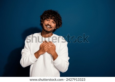 Photo of young sincere boyfriend saying his true love touching chest handsome cute mexican guy isolated on dark blue color background Royalty-Free Stock Photo #2427913323