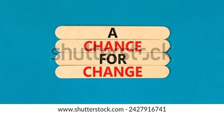 A chance for change symbol. Concept words A chance for change on wooden stick. Beautiful blue table blue background. Business A chance for change concept. Copy space.