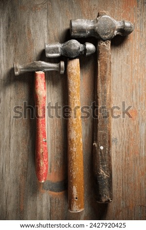 Close up of a disused hammers on a workbench. Royalty-Free Stock Photo #2427920425