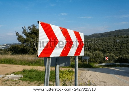 Close-up dangerous curve traffic sign and asphalt road in Turkey.