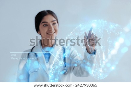 Doctor hand touching interactive picture 3D hologram of human DNA chain. Smiling young indian woman doctor geneticist and modern technology, grey background, double exposure, collage
