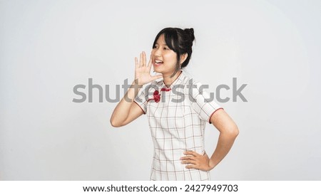 Young asian woman shouting and announcing something isolated on white background.