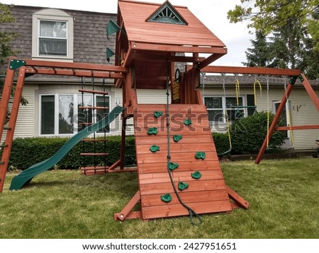 Suburban Home Backyard Complete Swingset Royalty-Free Stock Photo #2427951651