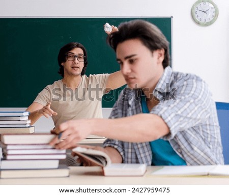 Two male students in the classroom Royalty-Free Stock Photo #2427959475