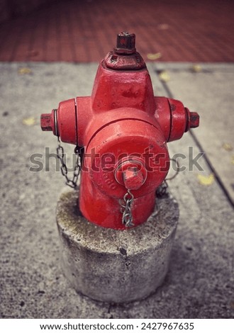 vintage red hydrant in city to put out fires with fire truck