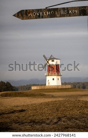 Mill with gray sky and signpost Royalty-Free Stock Photo #2427968141