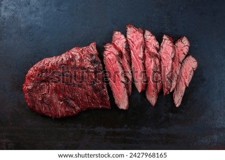 Traditional American barbecue bavette steak with salt and pepper served as top view on a rustic design board with copy space Royalty-Free Stock Photo #2427968165