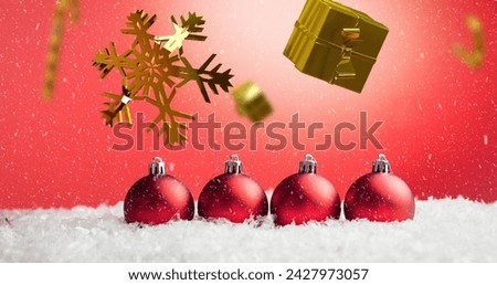 Image of candy canes and gifts christmas decorations with baubles on red background. Christmas, tradition and celebration concept digitally generated image.