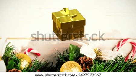 Image of merry christmas text over christmas decorations on wooden background. Christmas, tradition and celebration concept digitally generated image.