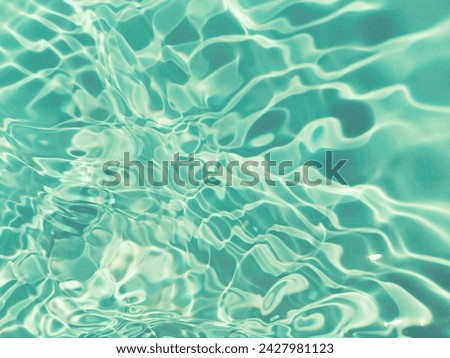 Abstract​ of​ surface​ blue​ water​ reflected​ with​ sunlight​ for​ background.Top​ view​ of blue​ water.​ Water​ splashed​ abstract​ background. Closeup​ blur​ abstract​ of​ surface​ blue​ water.