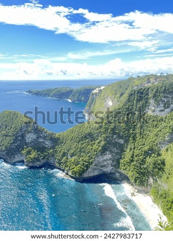 A landscape with beautiful beaches and cliffs. White sand, waves and blue skies in Paluang Cliff, Nusa Penida, Bali, Indonesia.