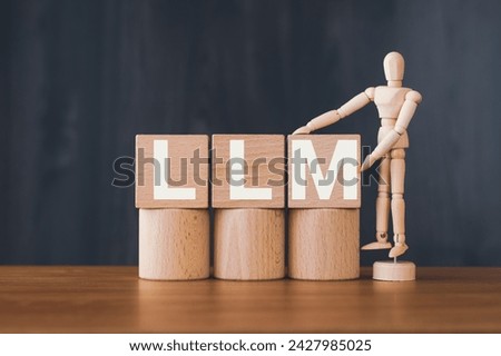 There is wood cube with the word LLM. It is an abbreviation for Large Language Models as eye-catching image. Royalty-Free Stock Photo #2427985025