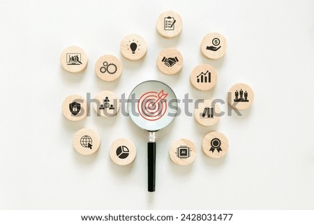 Targeting the business concept. Magnifying glass with red target icon on center and Business icons.Business strategy and Action plan, Business achievement goal, and objective target. 