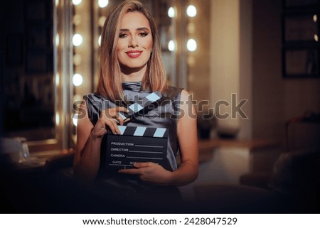 
Happy Actress Wearing Stage Makeup Holding a Film Slate 
Pretty leading lady filming a beauty commercial 
 Royalty-Free Stock Photo #2428047529