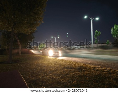Motion blur in a charming town with colorful lights and cars zooming by. The long exposure create a fairy-tale look.