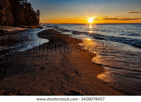 The sun is about to set over Lake Superior and the mouth of the Hurricane River, Pictured Rocks National Lakeshore, Alger County, Michigan