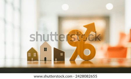 Percentage and house sign symbol icon wooden on wood table. Concepts of home interest, real estate, investing in inflation. Royalty-Free Stock Photo #2428082655
