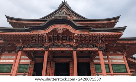A traditional Japanese building, possibly a temple or shrine, exhibiting classic architectural elements. The picture captures a traditional Japanese architectural structure