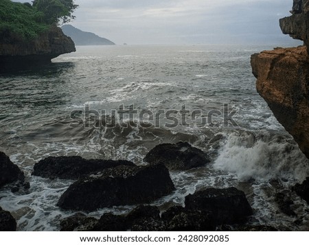 Picture of waves crashing into coastal rocks.