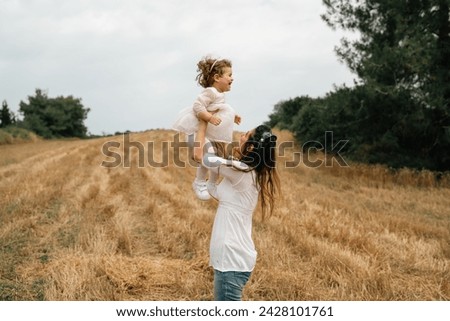 Happy family mother and her daughter in nature in summer stock photo
