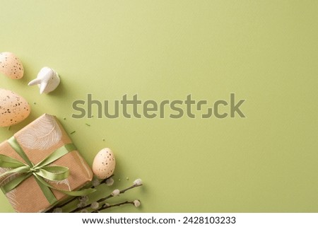 Homestead Easter layout design. Overhead capture of crafty box presentation, bunny, patterned quail eggs, cake decor, blooming pussy willow, all arranged on green surface with dedicated spot for ad
