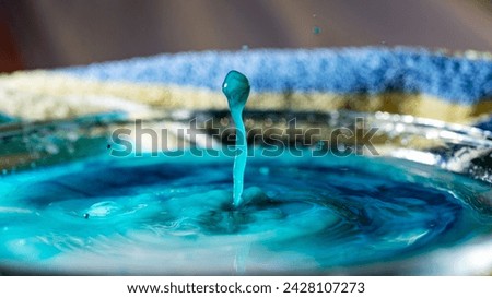 abstract picture with colored drop of various shapes, blurred background, water drop splash, close focus, grainy water texture