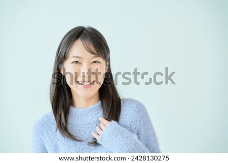 White background with smiling young woman Royalty-Free Stock Photo #2428130275
