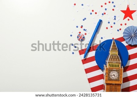 Big Ben with the flag of Great Britain on a light background.