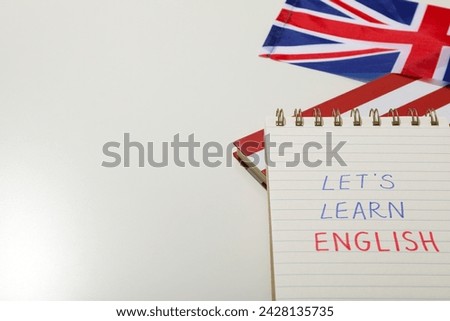 Notepad, Big Ben and the word "English" on a white background.