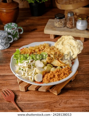 Ketoprak uses the main ingredients are tofu, ketupat or lontong, bean sprouts, crackers. You can also add boiled eggs. doused with peanut sauce, sweet soy sauce, and a sprinkling of fried shallots. Royalty-Free Stock Photo #2428138013