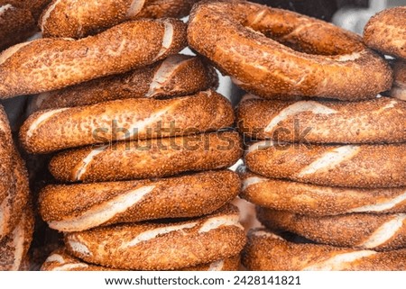 Traditional tasty Turkish bread semit withe sesame seeds sold everywhere across Turkey and popular for breakfast. Turkish breakfast. National food semite bun. Turkish Bagel Simit withe sesame seeds Royalty-Free Stock Photo #2428141821