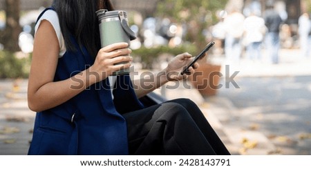 Asian businesswoman hold reusable eco friendly ecological cup while commuting in office