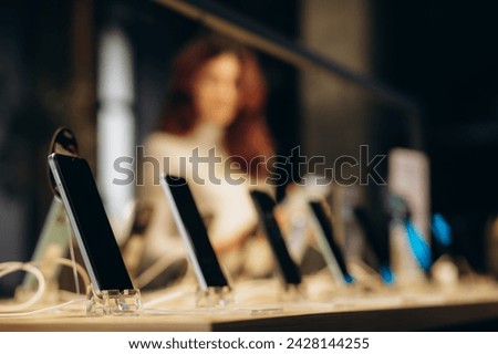  Smartphones store. Showcase with selling various new smartphones in electronics store during a sale. Mobile phone market concept. High quality photo