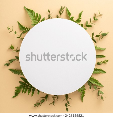 Simple natural beauty concept. High angle view square picture of empty circle surrounded by eucalyptus and bracken branches on isolated beige background with copy-space