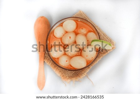 Asinan Rambutan or pickled rambutan is rambutan isolated on white background, seasoned with chili,lime and sugar.Indonesia's Favorite Summer Dessert.The other way to enjoy rambutan fruit..flat lay.