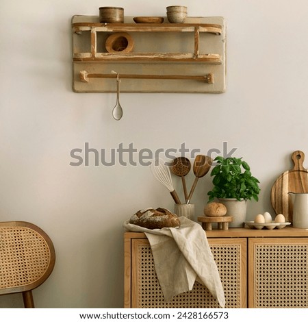 Interior design of kitchen space with rattan commode, boho chair, ladder,  cutting board, herbs, vegetables, bread, eggs, pitcher, food and kitchen accessories. Home decor.  Template. 