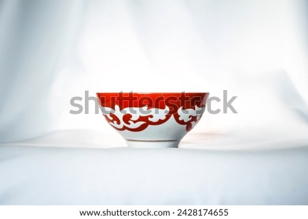 Kazakh piala. Central Asia traditional tea cup with national ornament. National red bowl isolated on white background Royalty-Free Stock Photo #2428174655