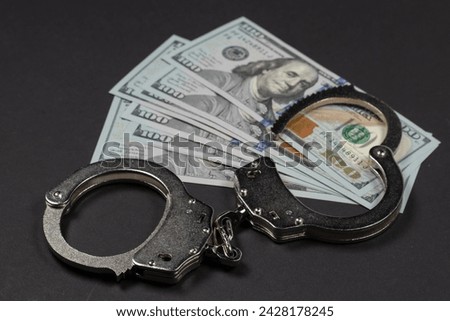 The handcuffs are on hundred-dollar bills. Power and bribery. Criminal ransom. Criminal earnings. Business concept. The concept of wealth.