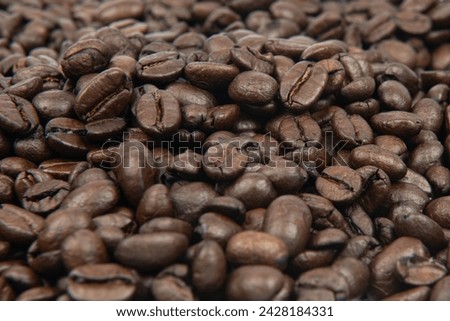 Coffee bean background. Roasted coffee beans on the entire surface. Brown coffee. Flat layout with top view.