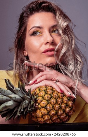 beautiful blonde woman with yellow makeup and pineapple creative makeup 