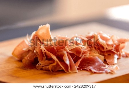 delicious prosciutto close-up on wooden board stock photo