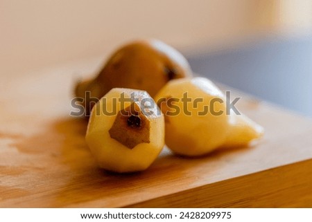 delicious peeled pears close-up on wooden board stock photo