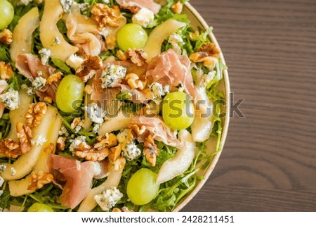 delicious salad with prosciutto, grape, and arugula