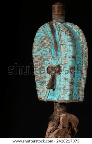 Wooden Kota reliquary figure from Gabon, isolated on a black background. Tribal African art, showcasing masterful craftsmanship and spiritual symbolism. Royalty-Free Stock Photo #2428217373