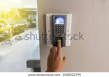 Finger scan on Finger scanner machine Security concept and safety. Businessman hand scanning finger on machine.                               Royalty-Free Stock Photo #2428222795